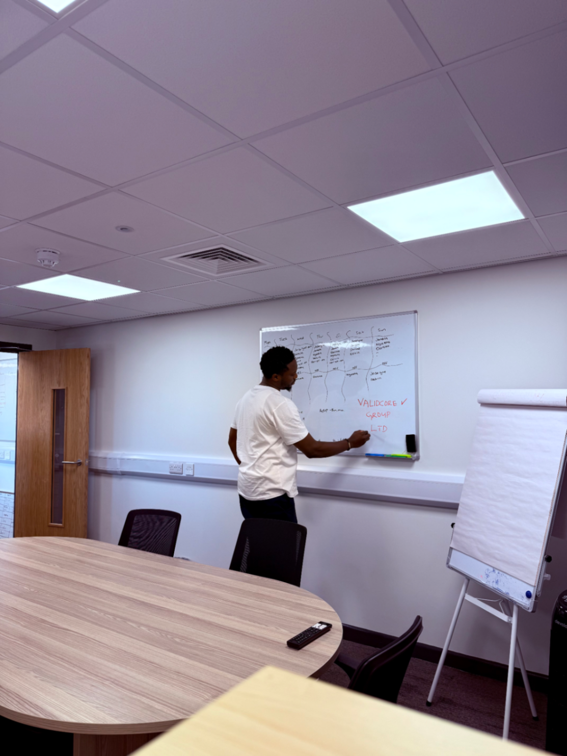 ValidCore supervisor mapping out a weekly service schedule on a boardroom whiteboard