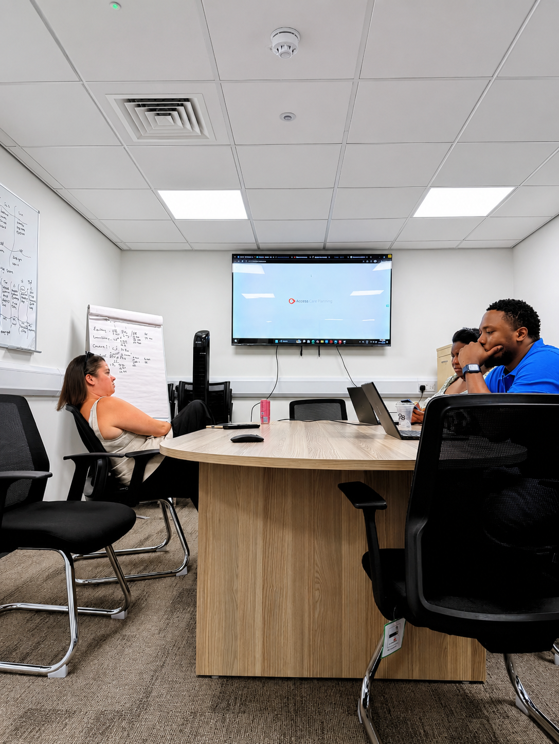 ValidCore management team in a strategy meeting reviewing operations on screen